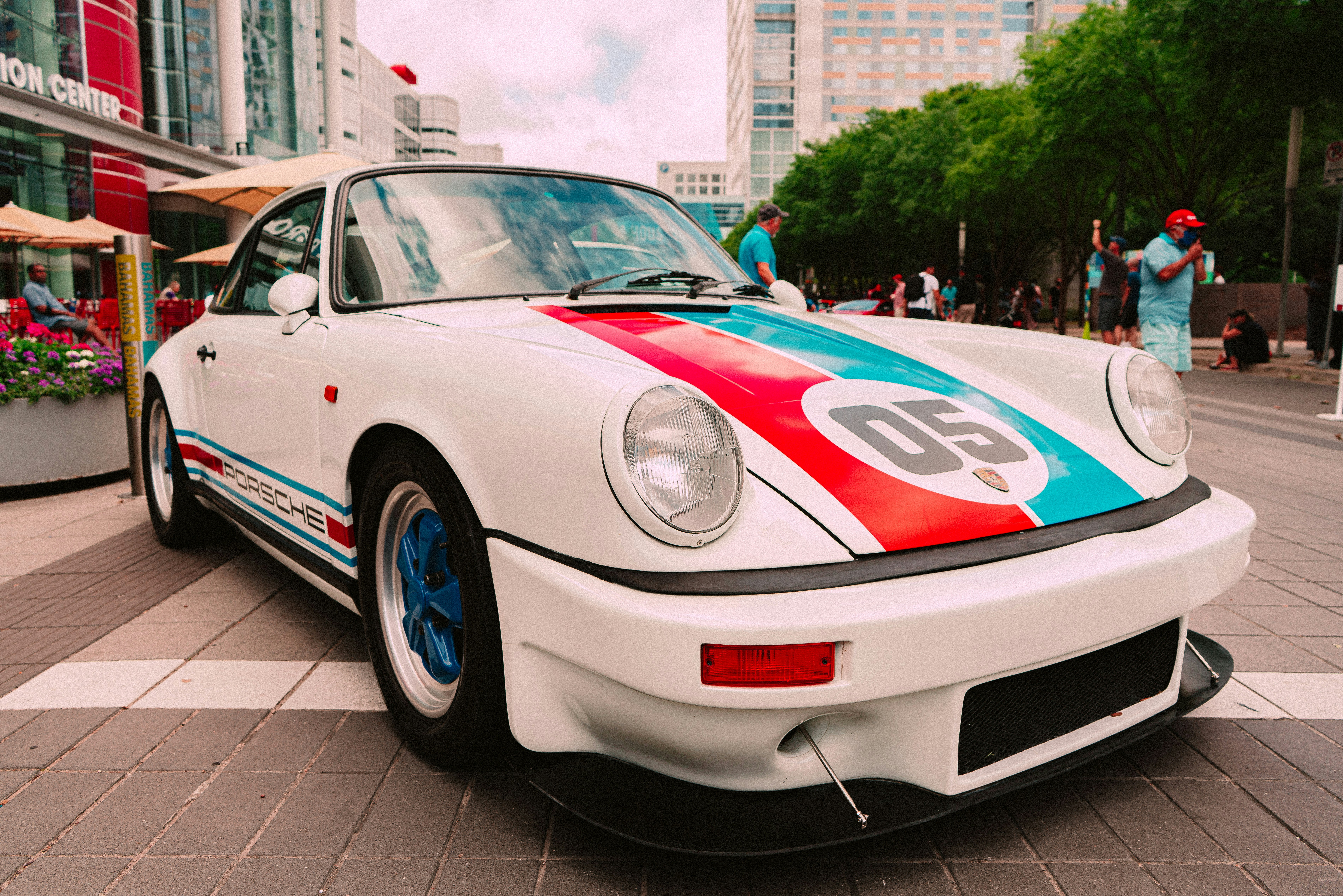 white porsche 911 parked on gray pavement